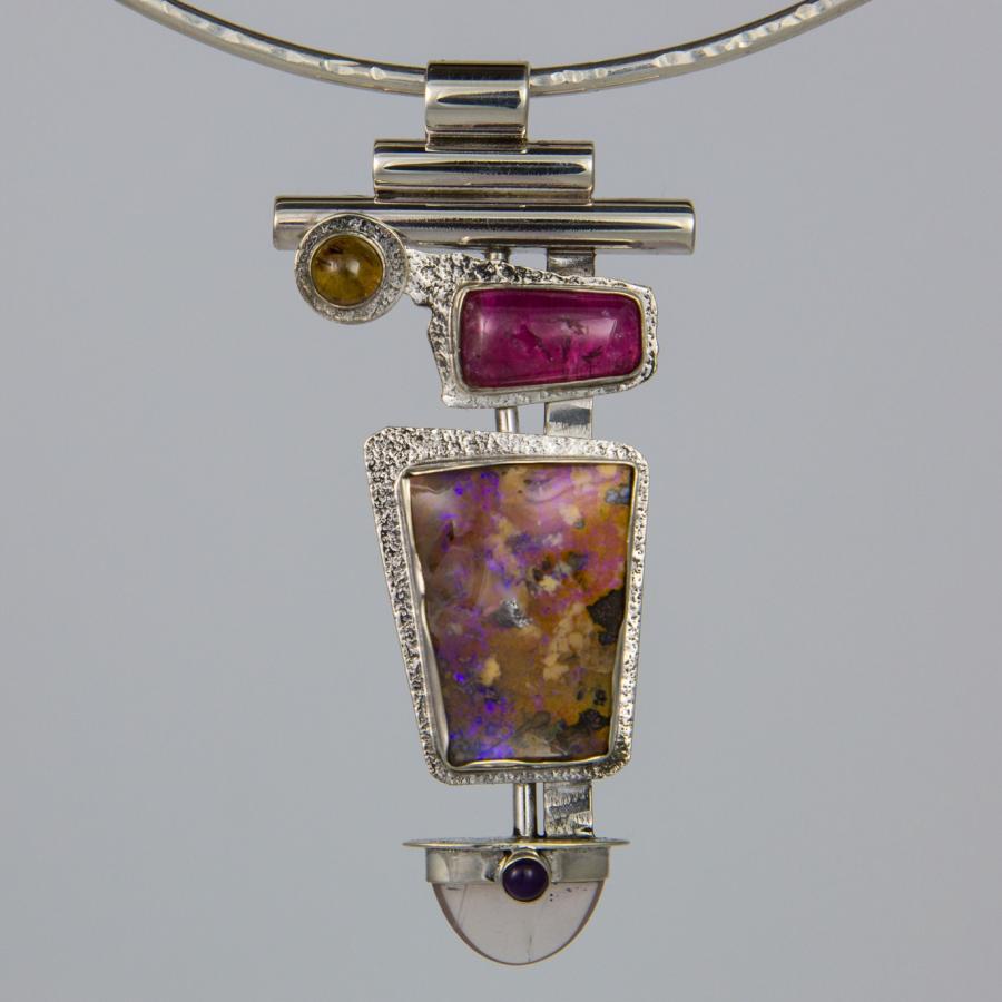 Silver necklace with an abstract colorful pendant.