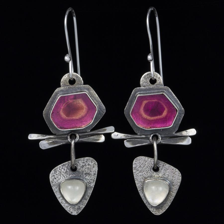 Photograph of silver and pink colored earrings.