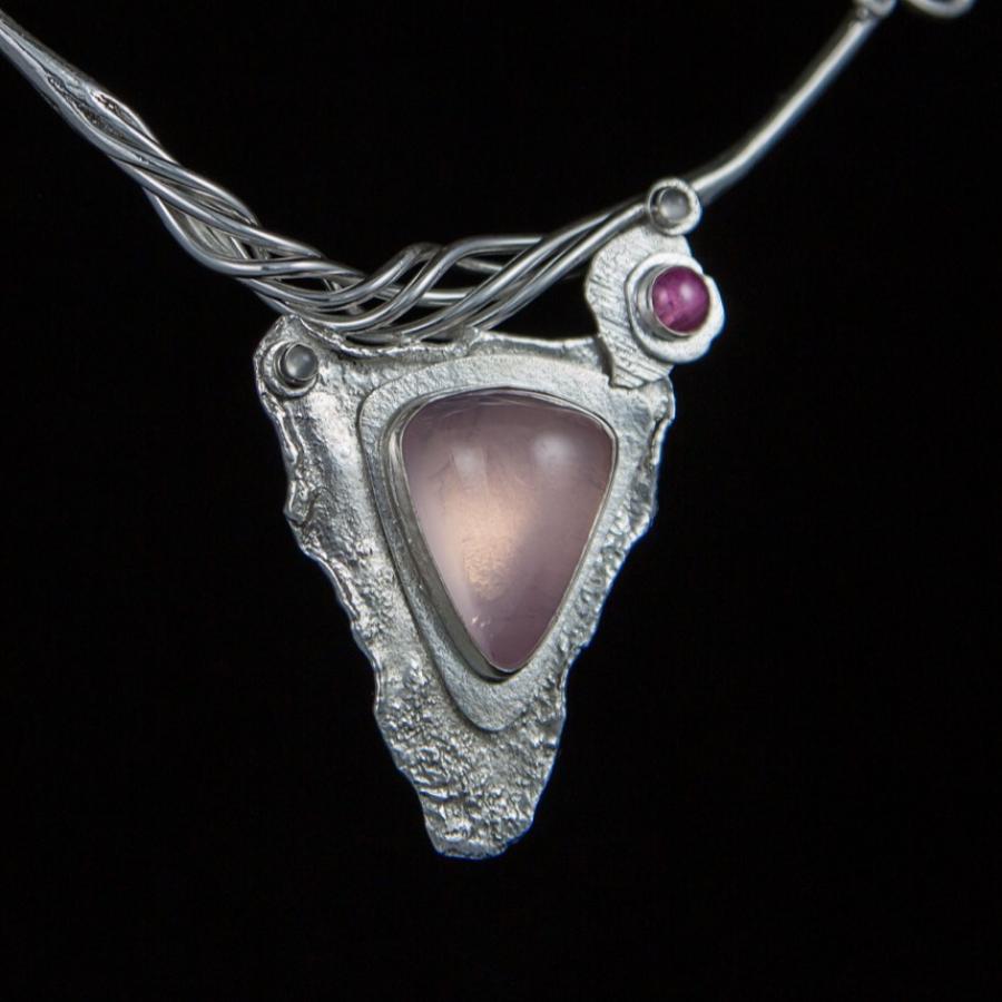 Silver necklace with pink triangle stone pendant.