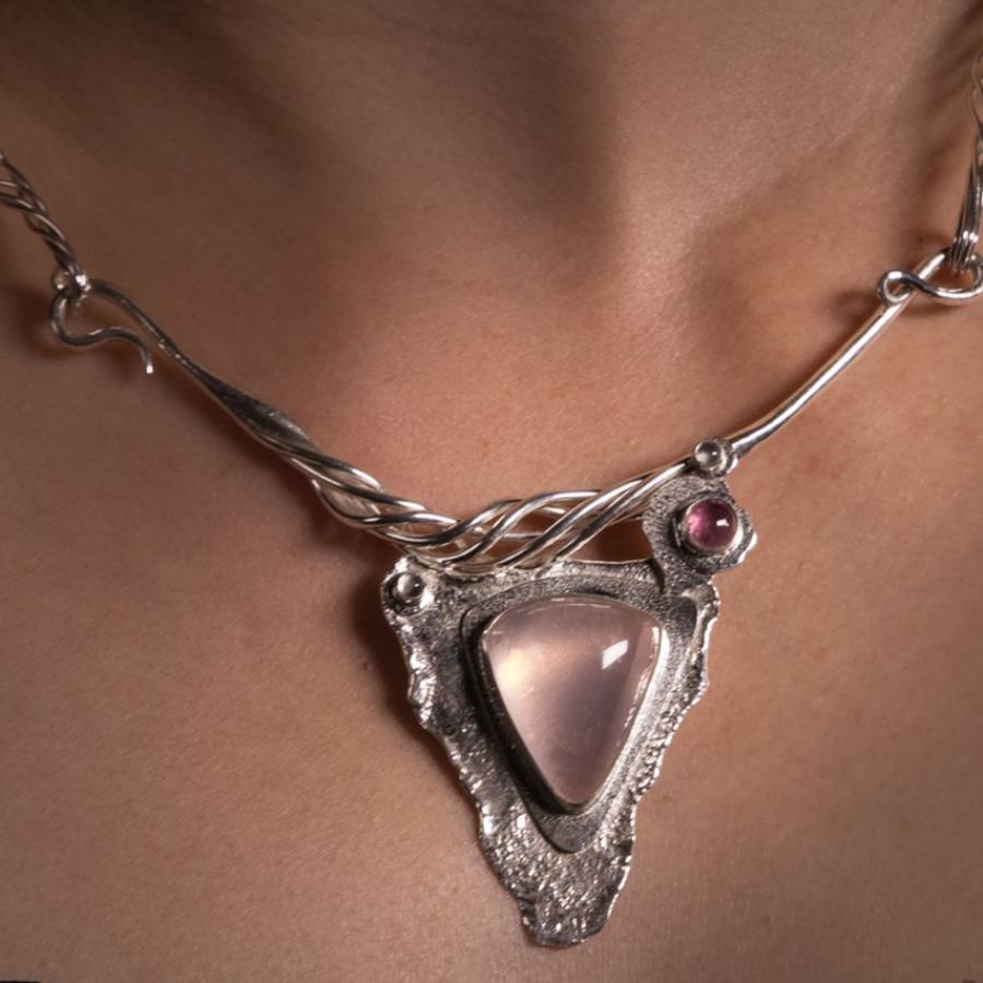 Woman wearing an ornate silver necklace.
