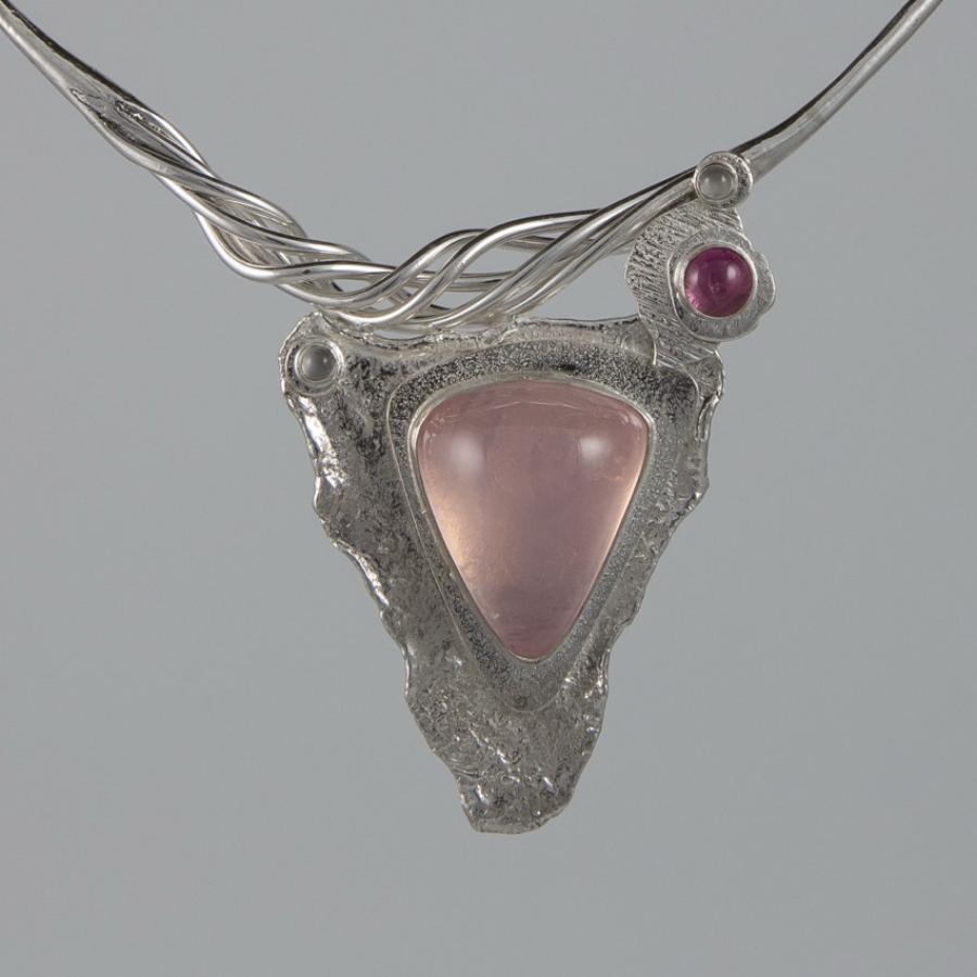 Silver necklace with pink triangle pendant.