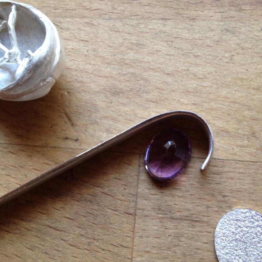 Jewelry making materials on wooden table.