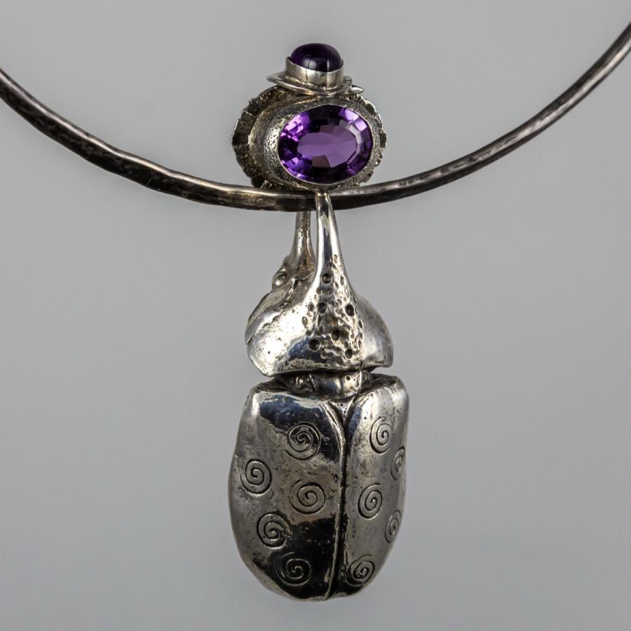Necklace with silver beetle and amethyst.