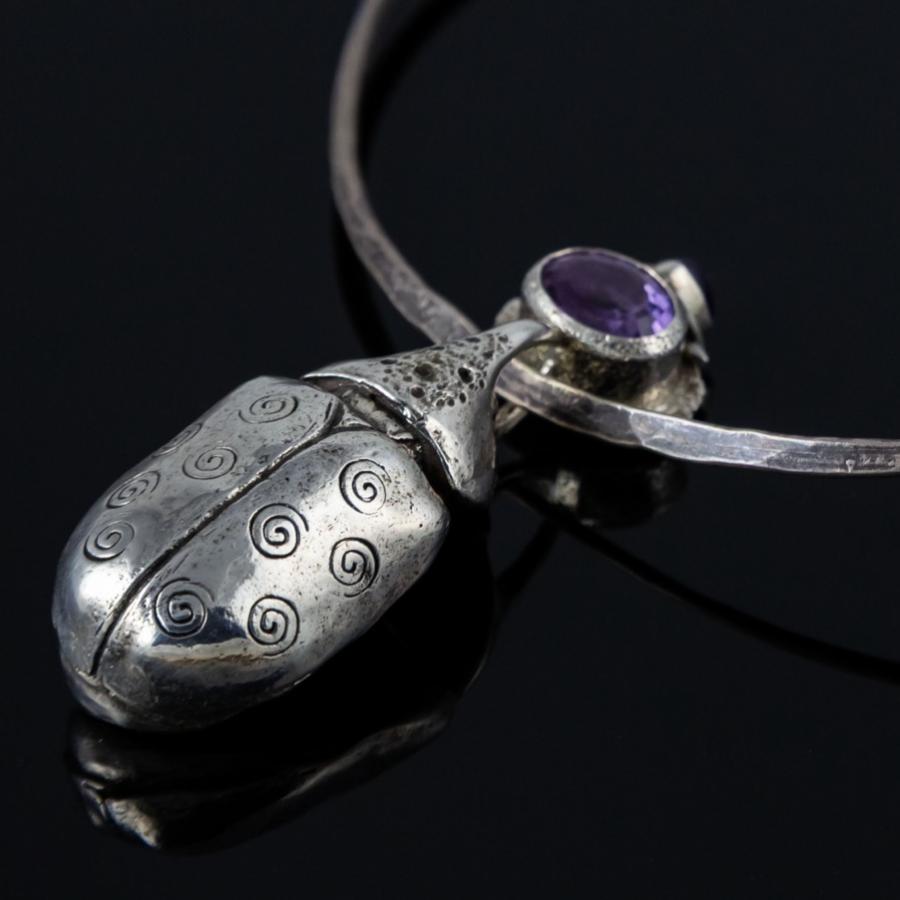 Silver beetle necklace.
