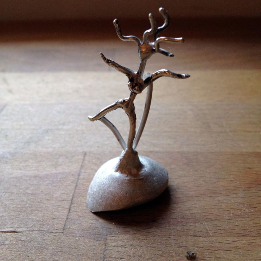 Cast model of a stick figure woman.