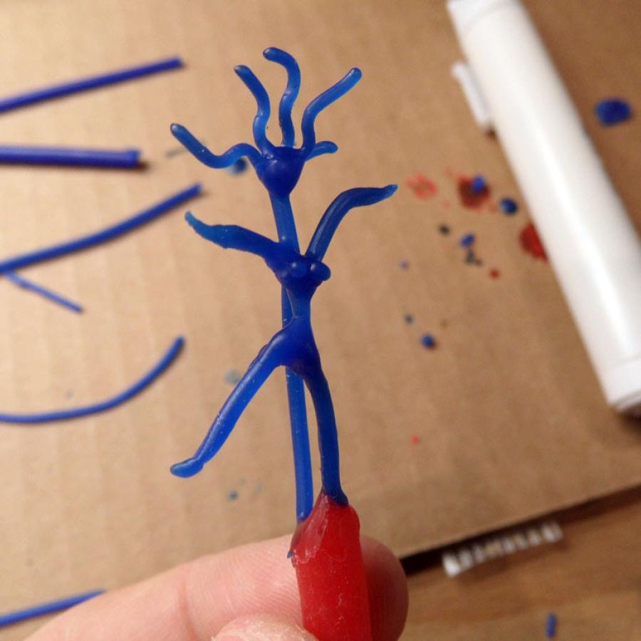 Blue wax sculpture of a woman.