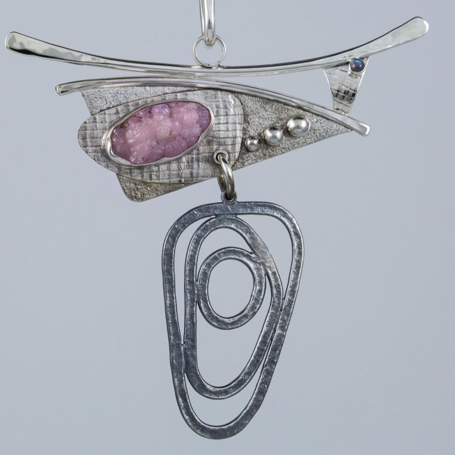 Silver necklace with pink gem.