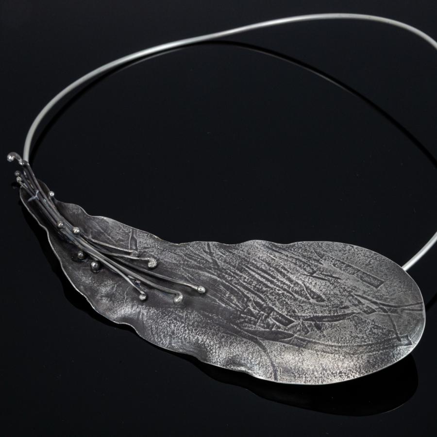 Silver leaf pendant necklace, photograph.