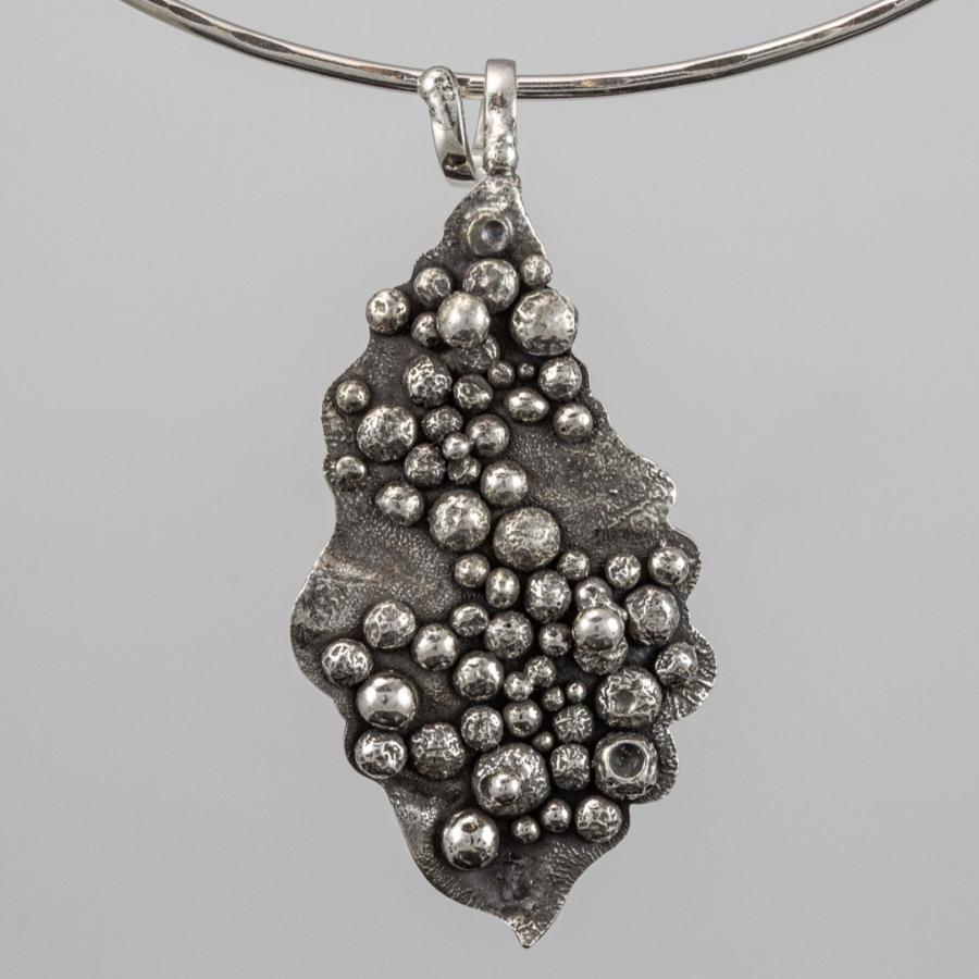 Silver necklace with abstract pendant.