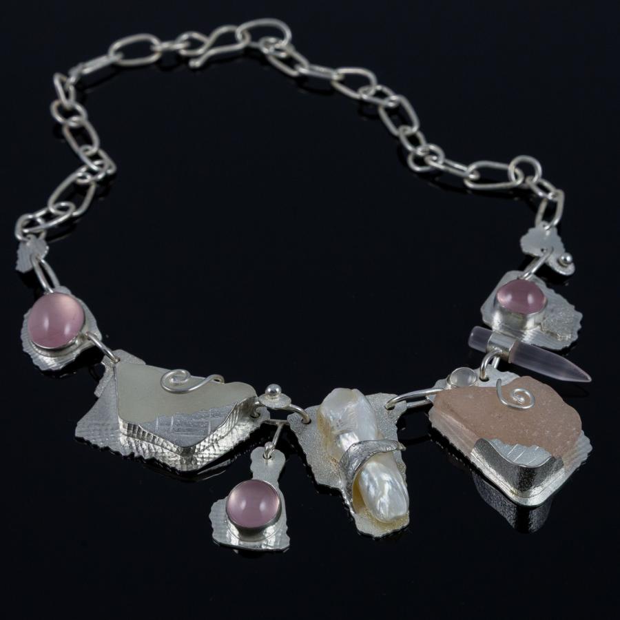 Handcrafted silver necklace with gems, photograph.