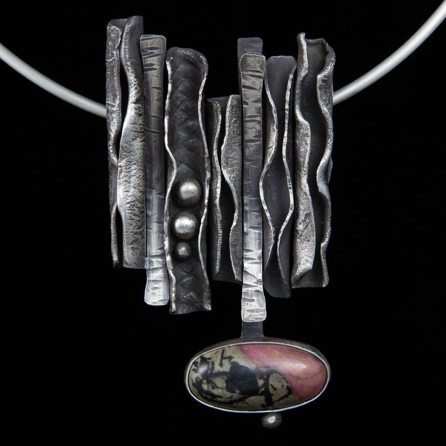 Silver pendant necklace with pink stone.