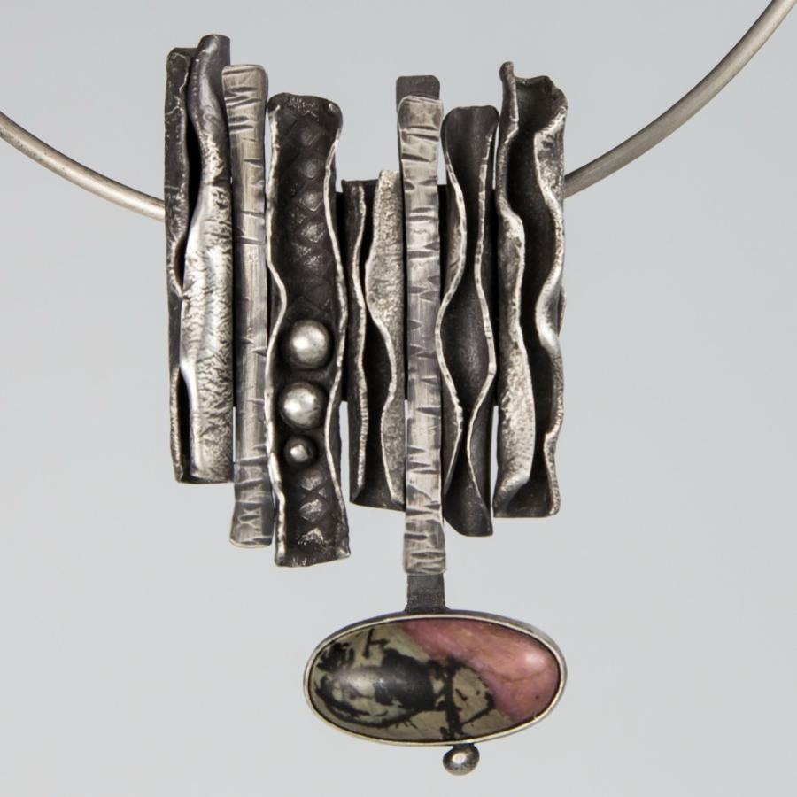 Silver pendant necklace with pink stone.