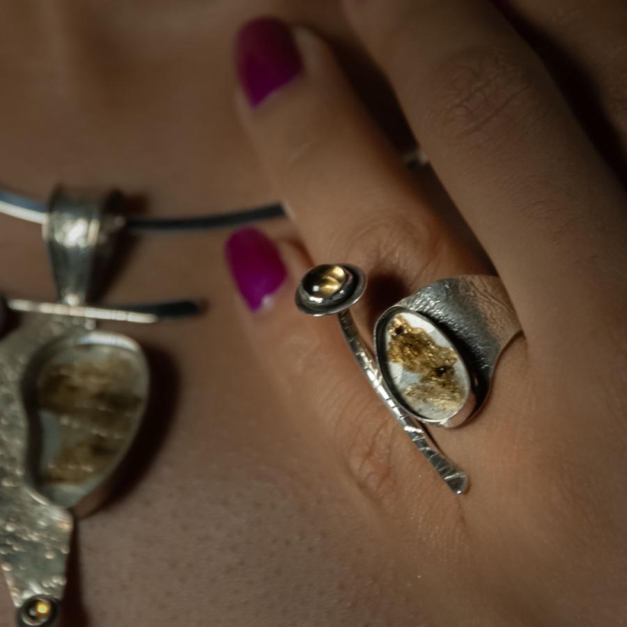 Woman wearing a necklace and ring jewelry set