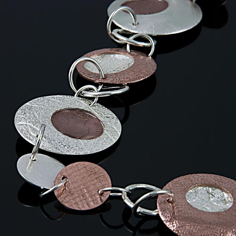 Necklace with copper and silver circles and pennies.