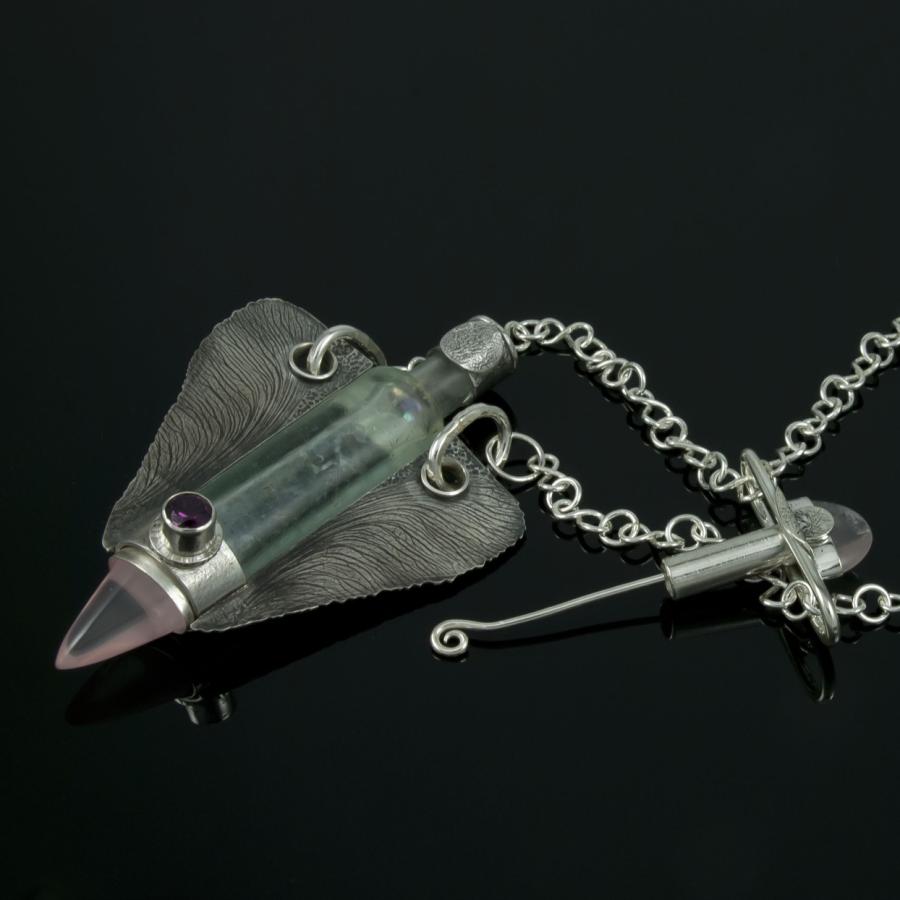 Silver necklace with glass bottle, stones.