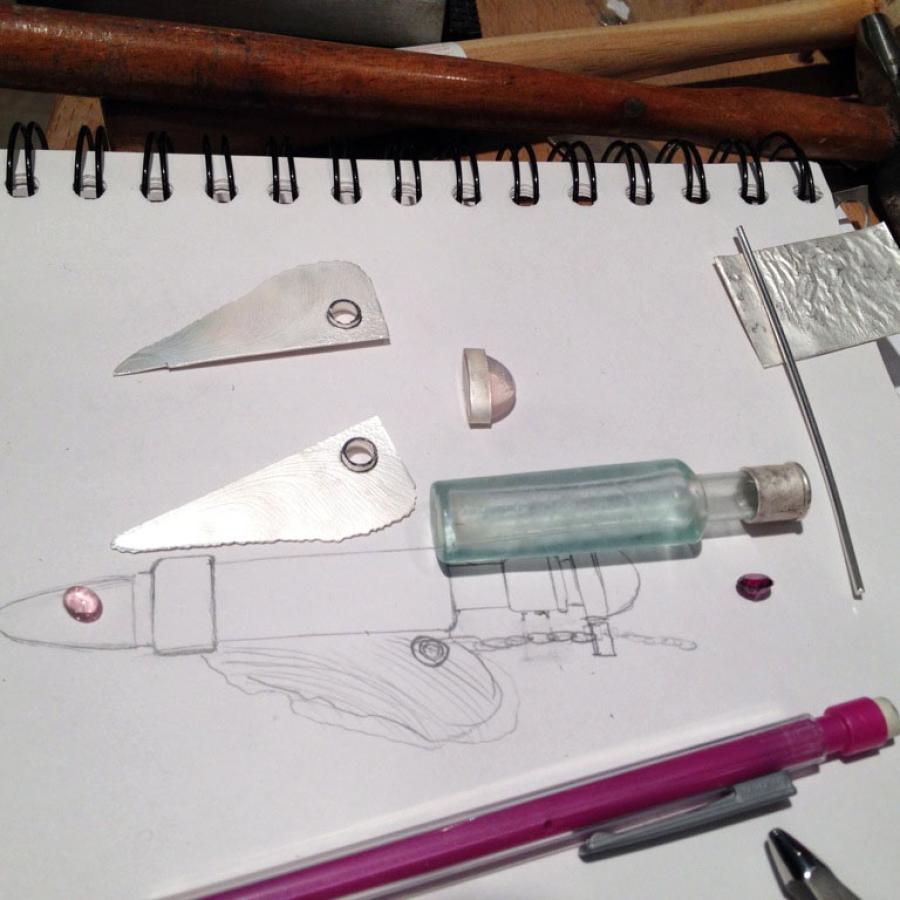 Jewelry design sketch with silver components.