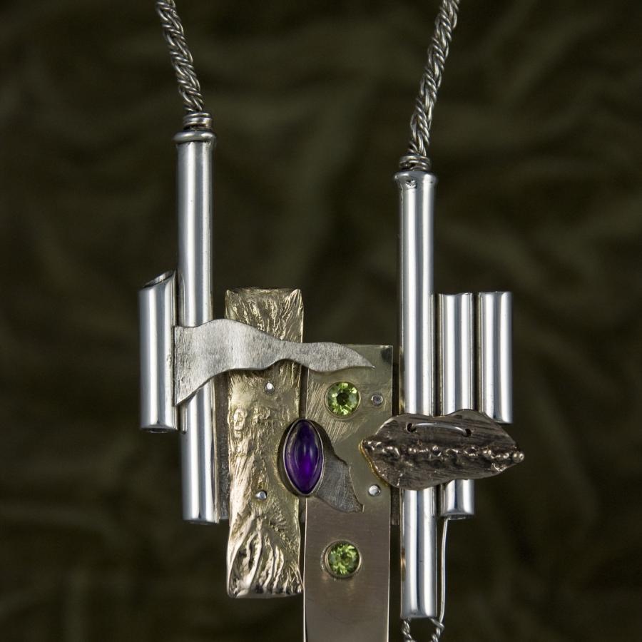 Handmade necklace with metallic and gemstone details.