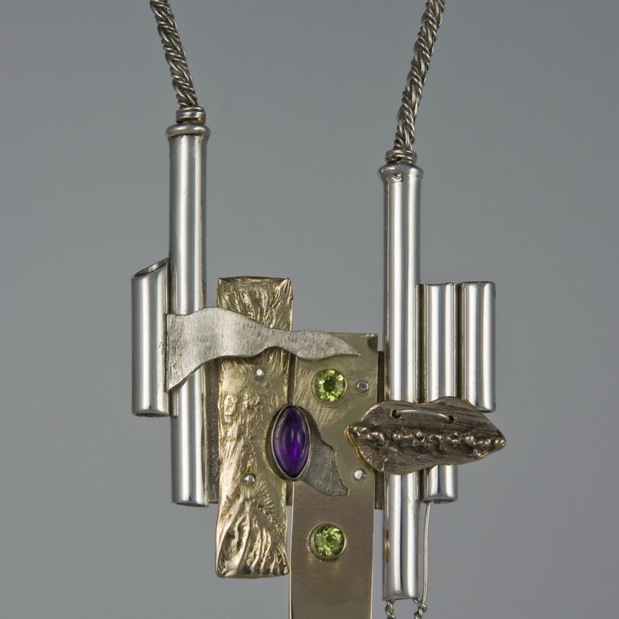 Handmade necklace with metallic and gemstone details.