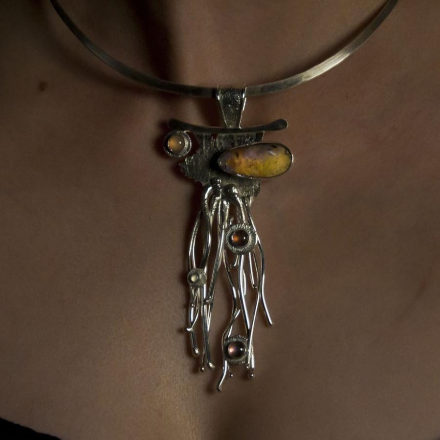 Woman wearing silver necklace.