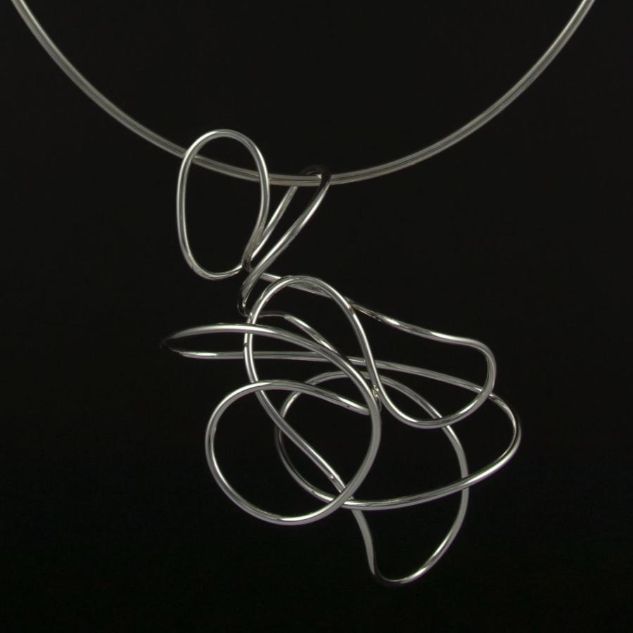 Silver necklace with flowing, looping design.