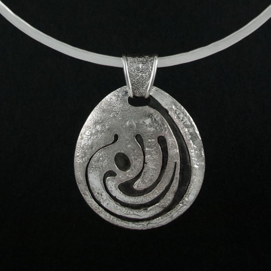 Silver torque necklace with patterned pendant.