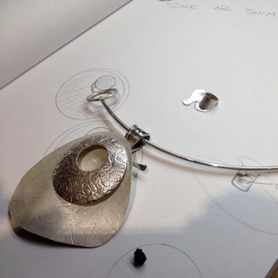 Jewelry design sketch with pendant necklace.