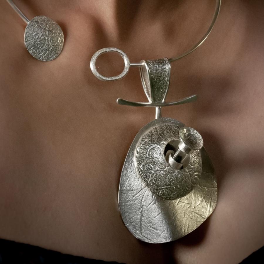 Woman wearing a silver statement necklace.