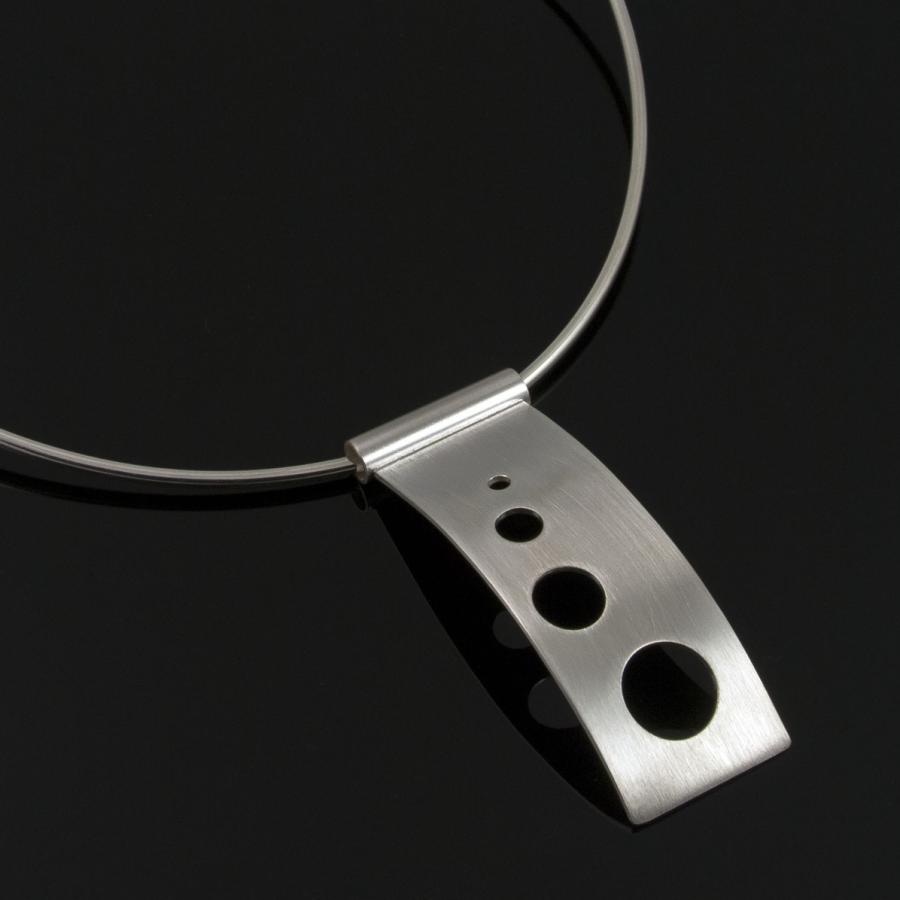 Silver necklace with cutout circles.