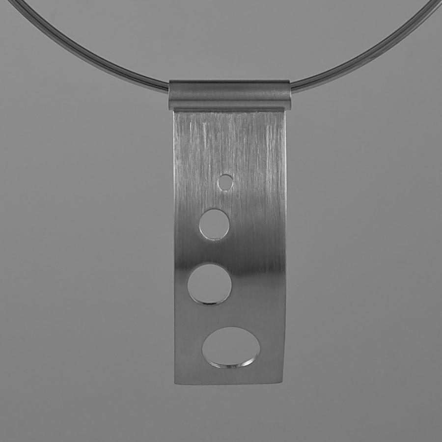 Silver necklace with cutout circles.