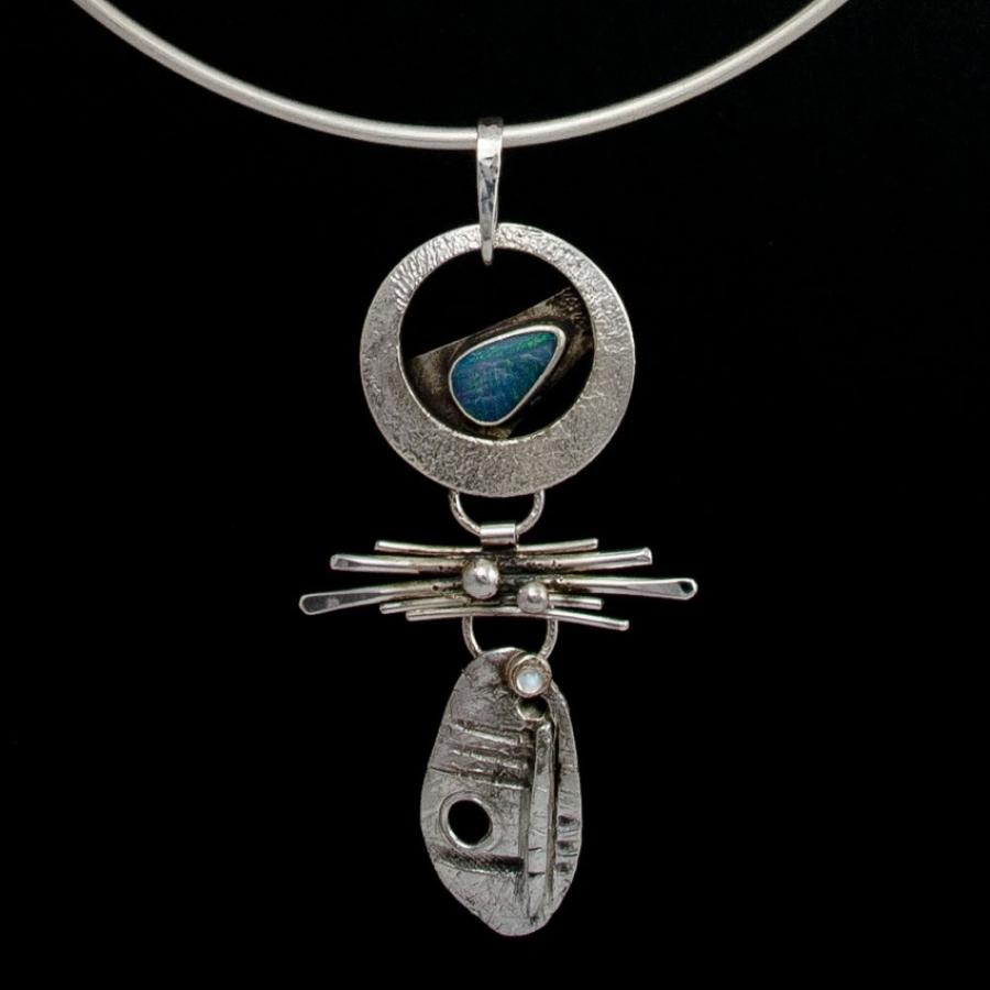 Silver necklace with opal pendant, photograph.