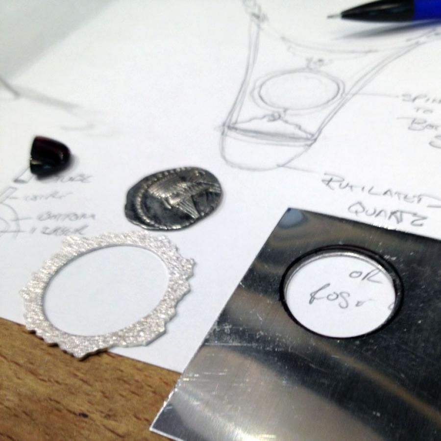 Jewelry design, pencil, components, and notes photograph.