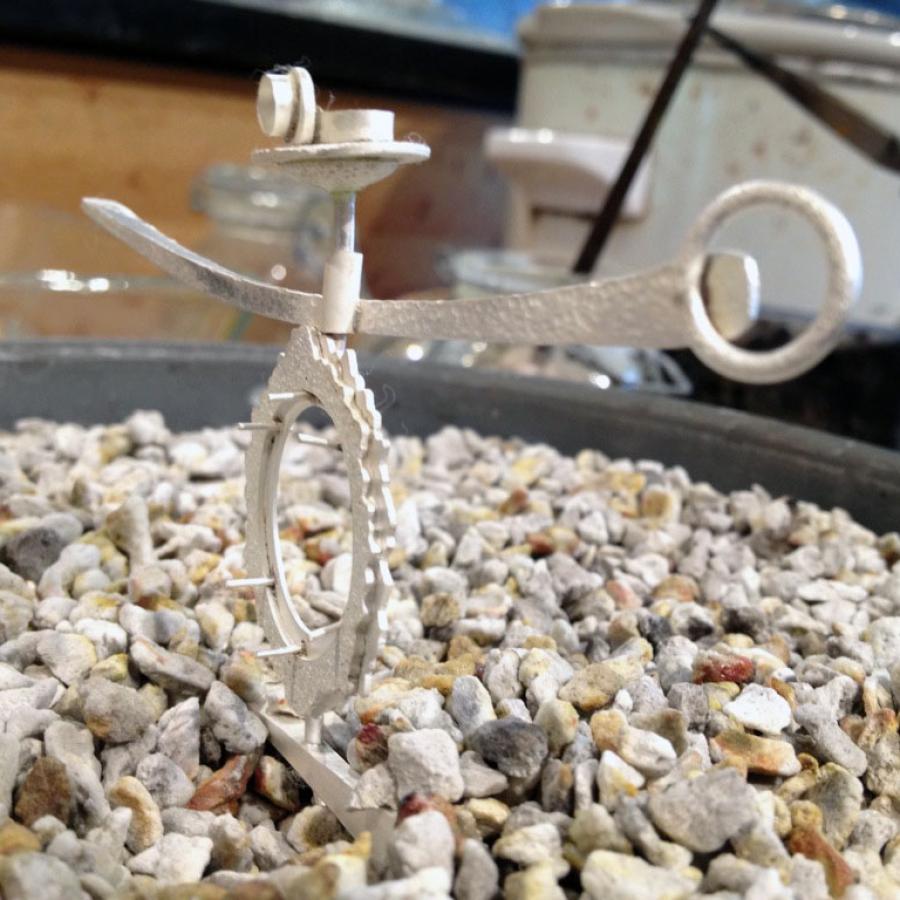 Photograph of jewelry components staged for soldering