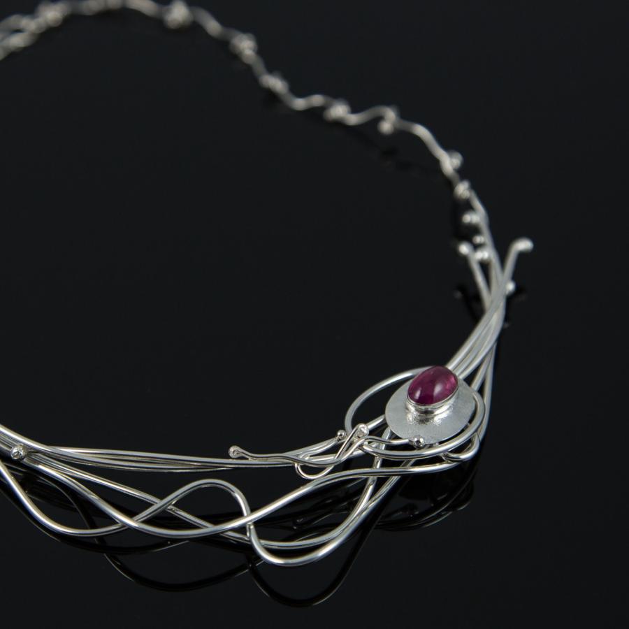 Silver necklace with pink stone.