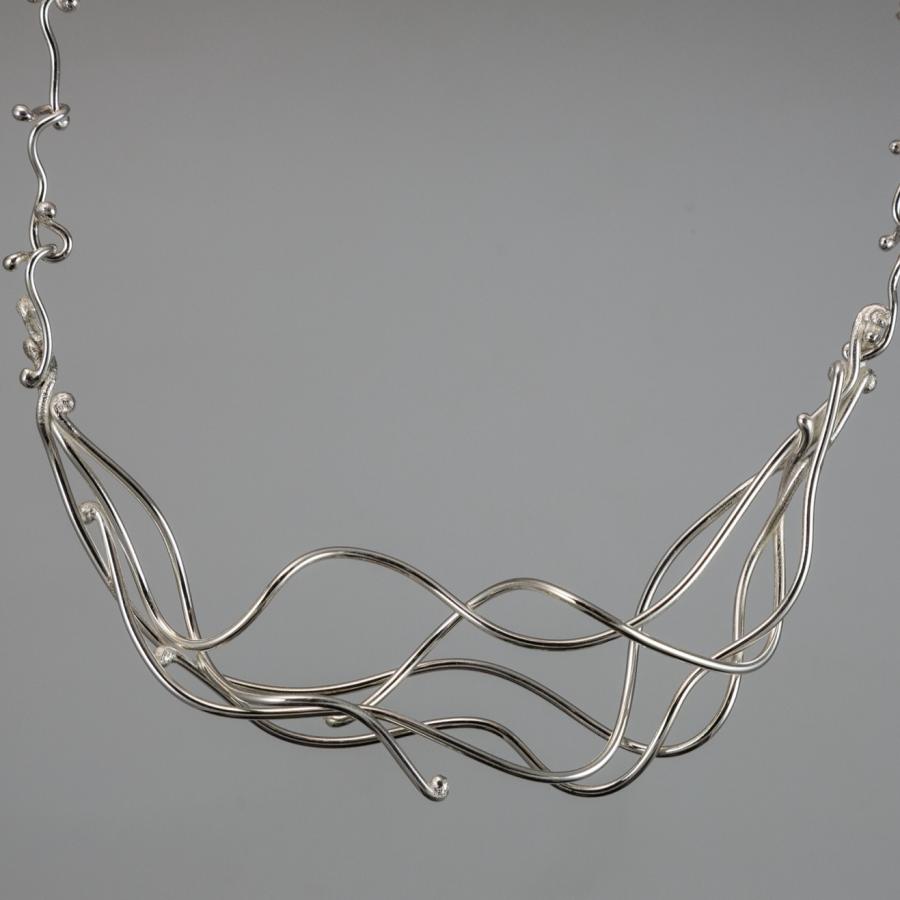 Silver strand necklace, photograph.