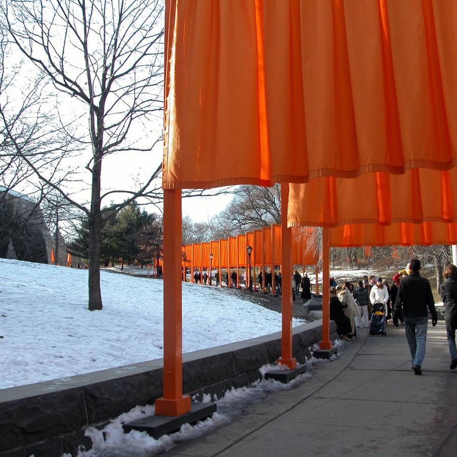 Orange fabric art installation in a snowy park, photograph.