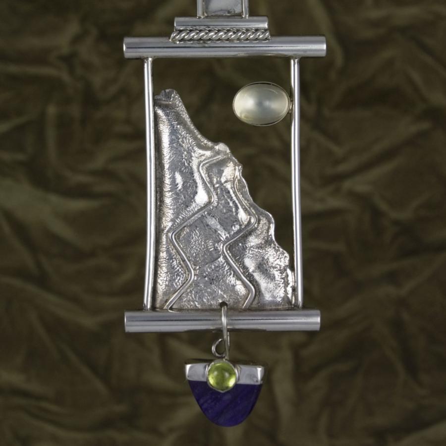 Silver mountain pendant necklace, jewelry photograph.