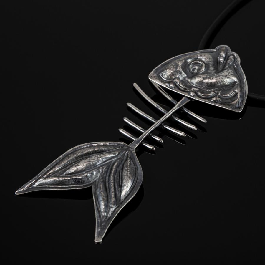Silver fish skeleton pendant on black cord.