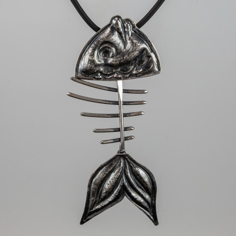 Silver fish skeleton pendant on a black cord.