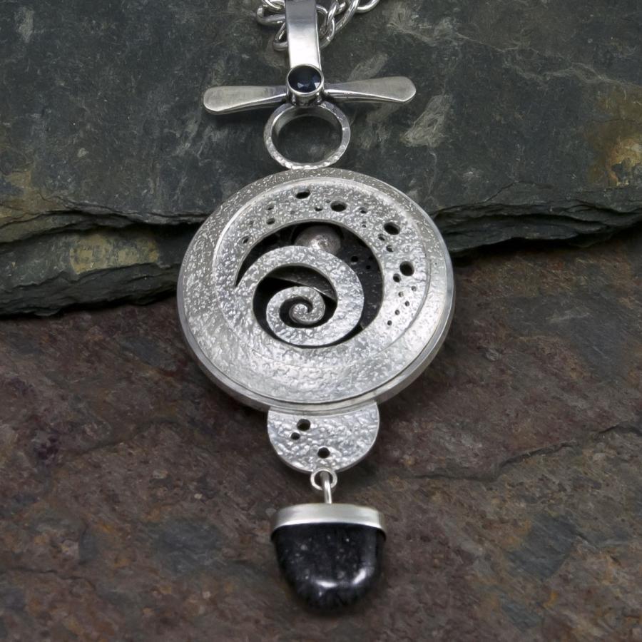 Silver spiral pendant necklace, photograph.