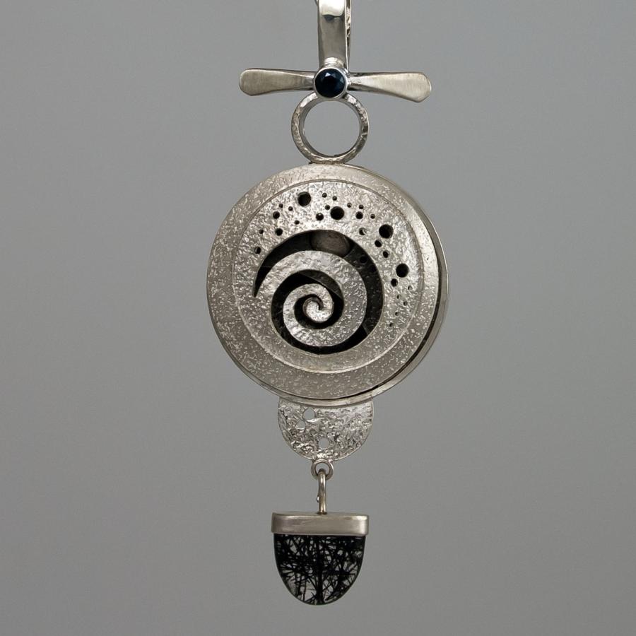 Silver necklace with spiral pendant, close-up.