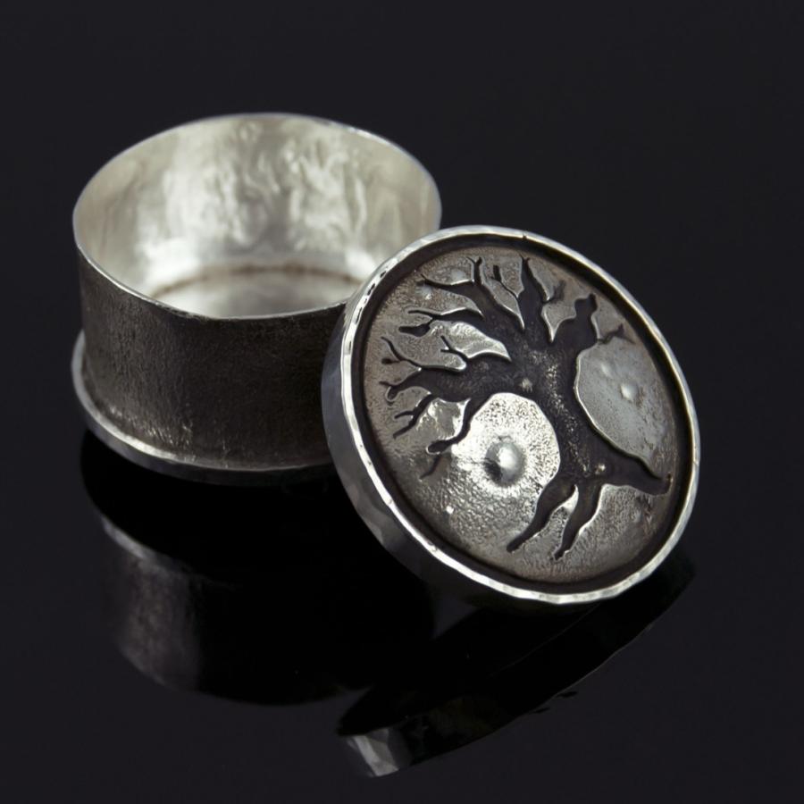 Small silver box with tree graphic on lid.