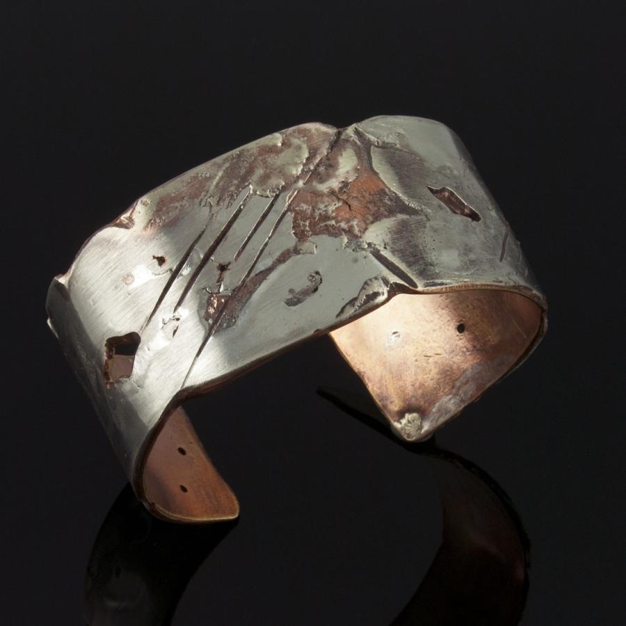 Metal cuff bracelet with a distressed finish.