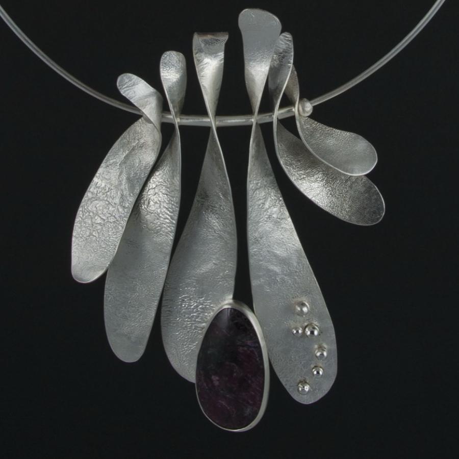 Silver necklace with leaf-like pendants, red stone.