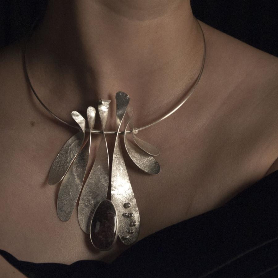Woman wearing a metal statement necklace.