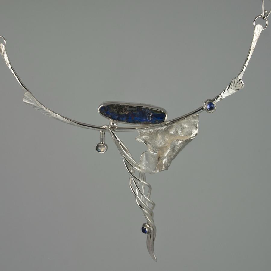 Silver necklace with blue stone detail.