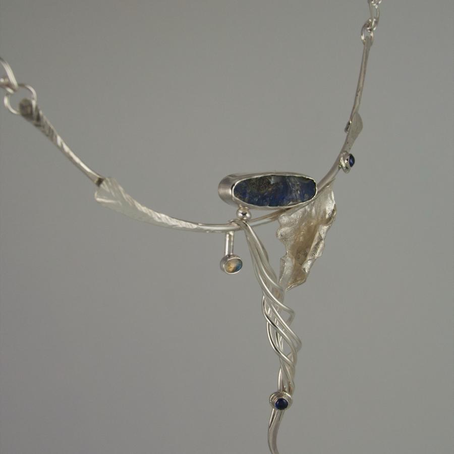 Silver necklace with blue stones, close-up.