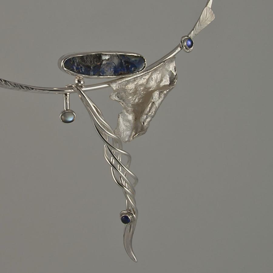 Silver necklace with blue stones, photograph.