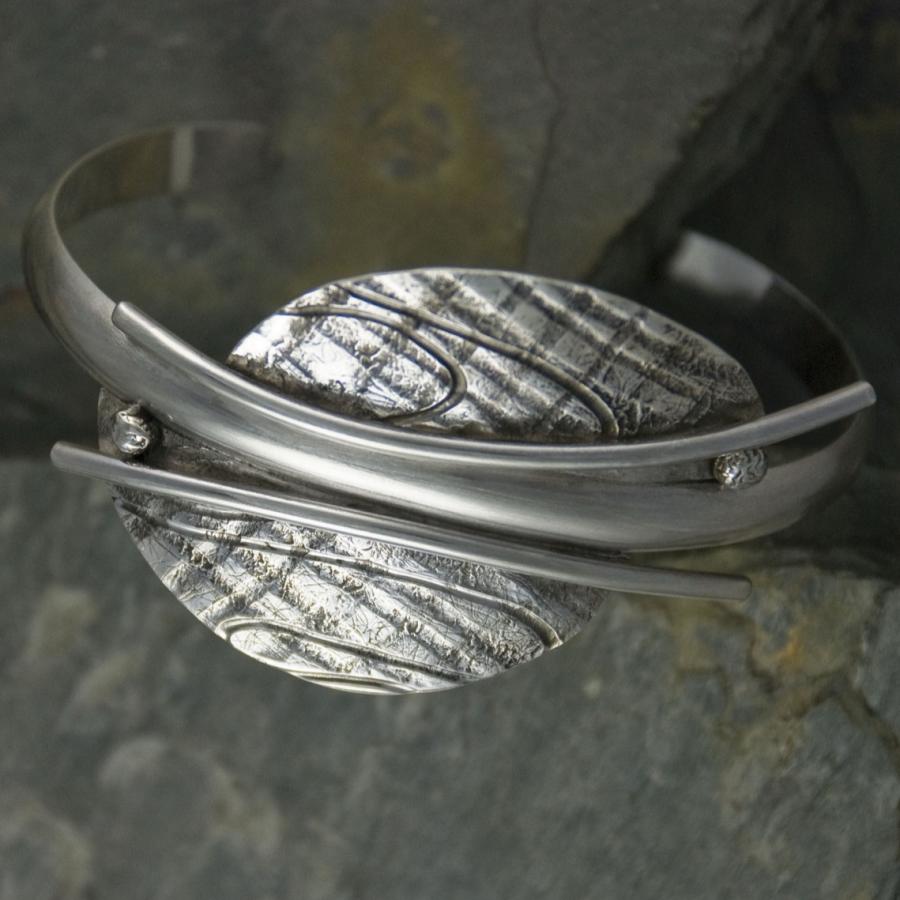 Silver bracelet with textured wings