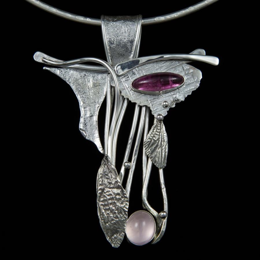 Silver pendant with pink stones.