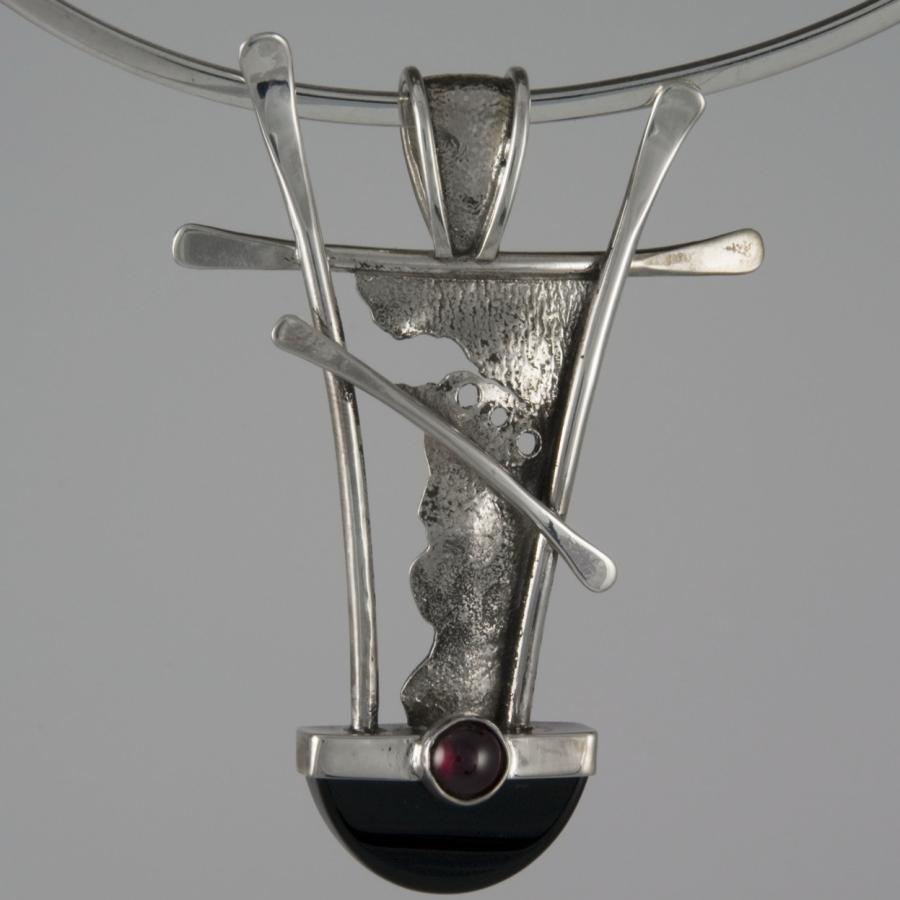 Silver pendant necklace with black and red stone.